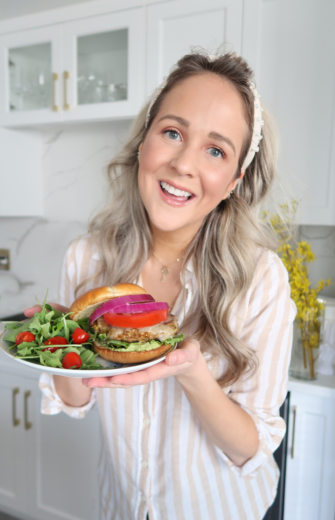 Award winning blogger Kayla Short poses with a turkey burger and side salad