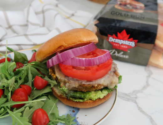 Turkey burger with tomato and onion served with a side salad